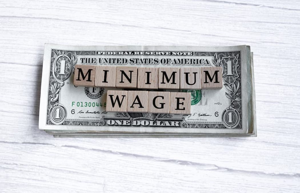 Image for article; Minimum Wage spelled out on top of dollar bills
